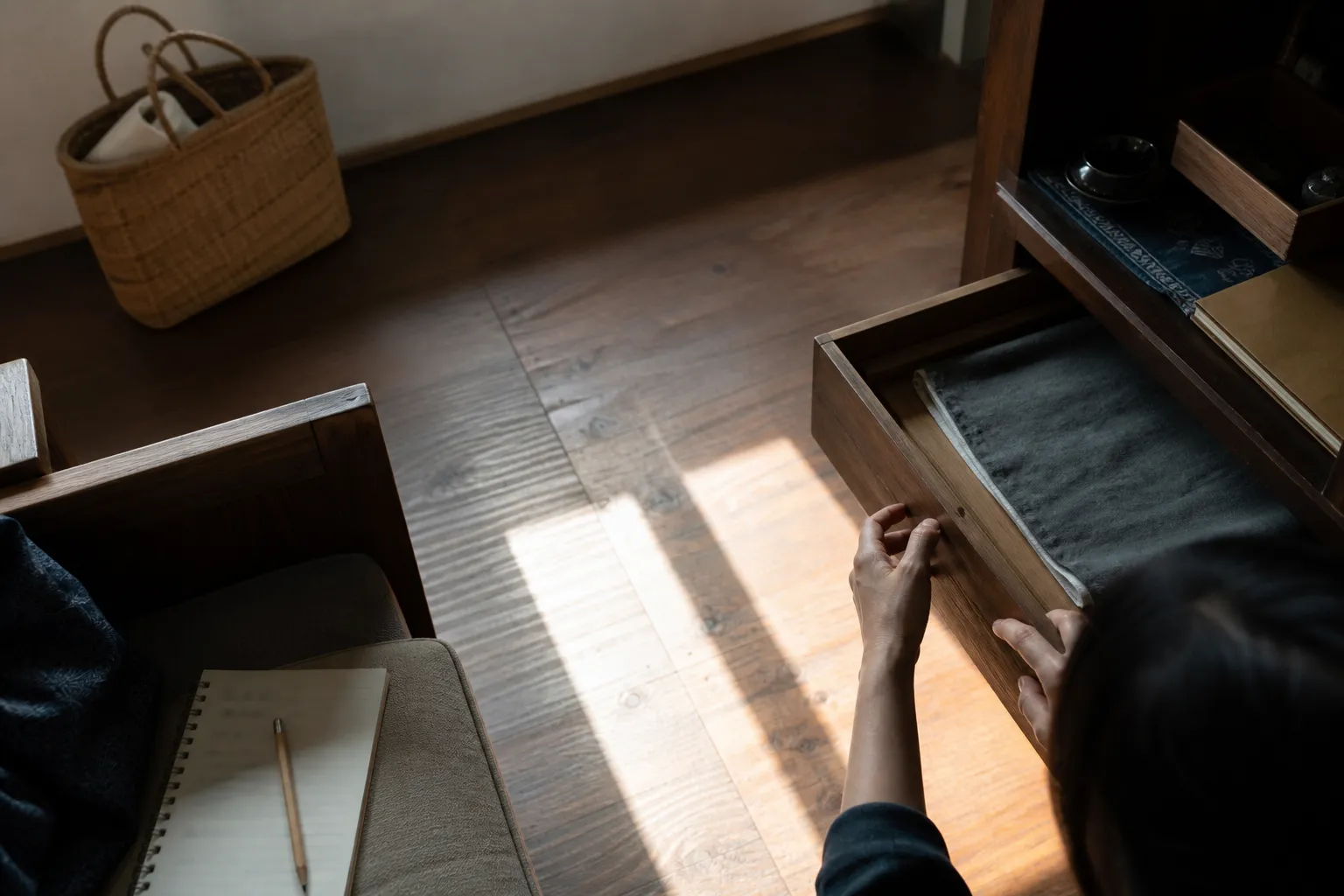 A quiet indoor check of sun patches, drawers, woven baskets, and furniture spacing near walls