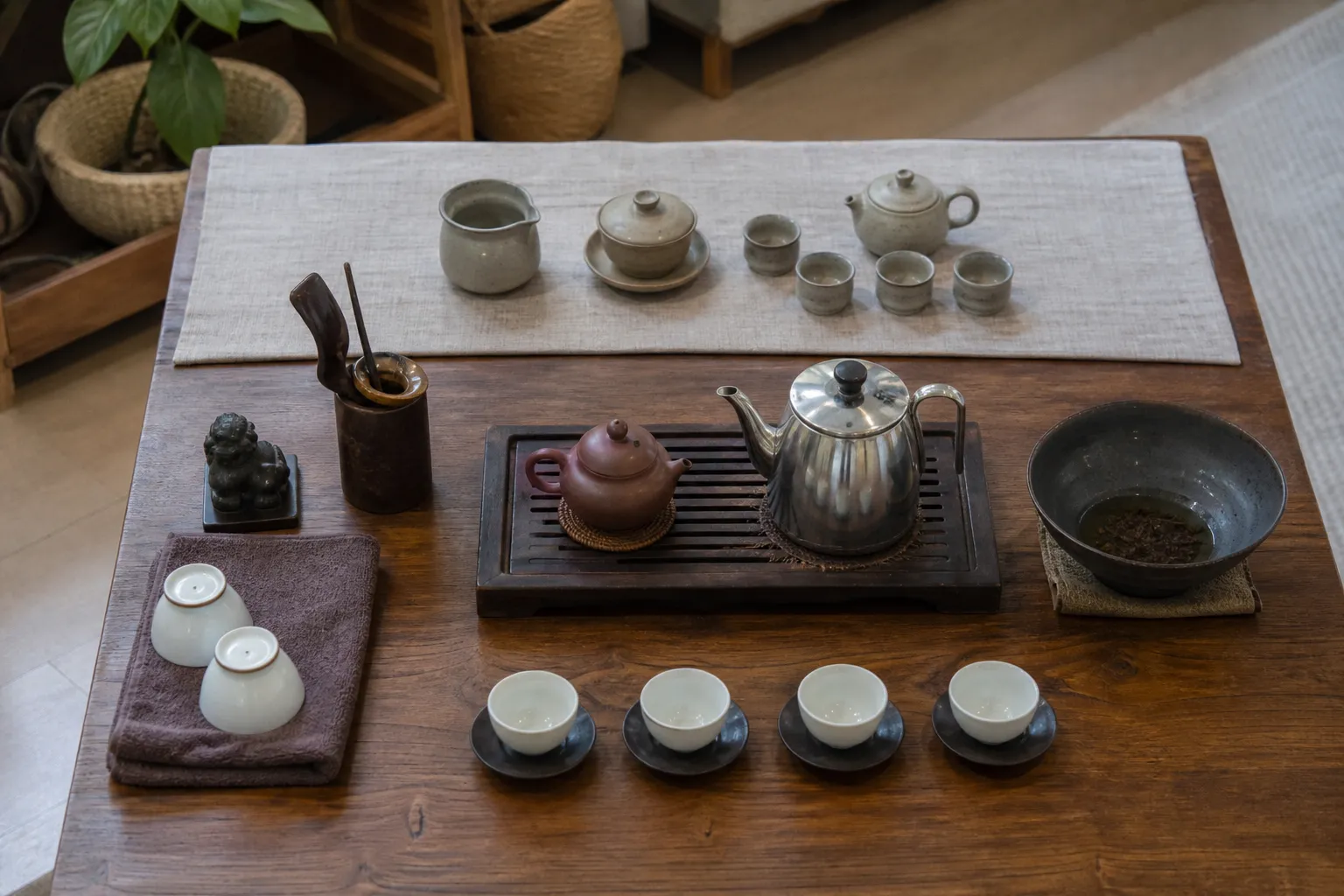 A simple tea table arranged into brewing, drinking, waste, storage, and display zones